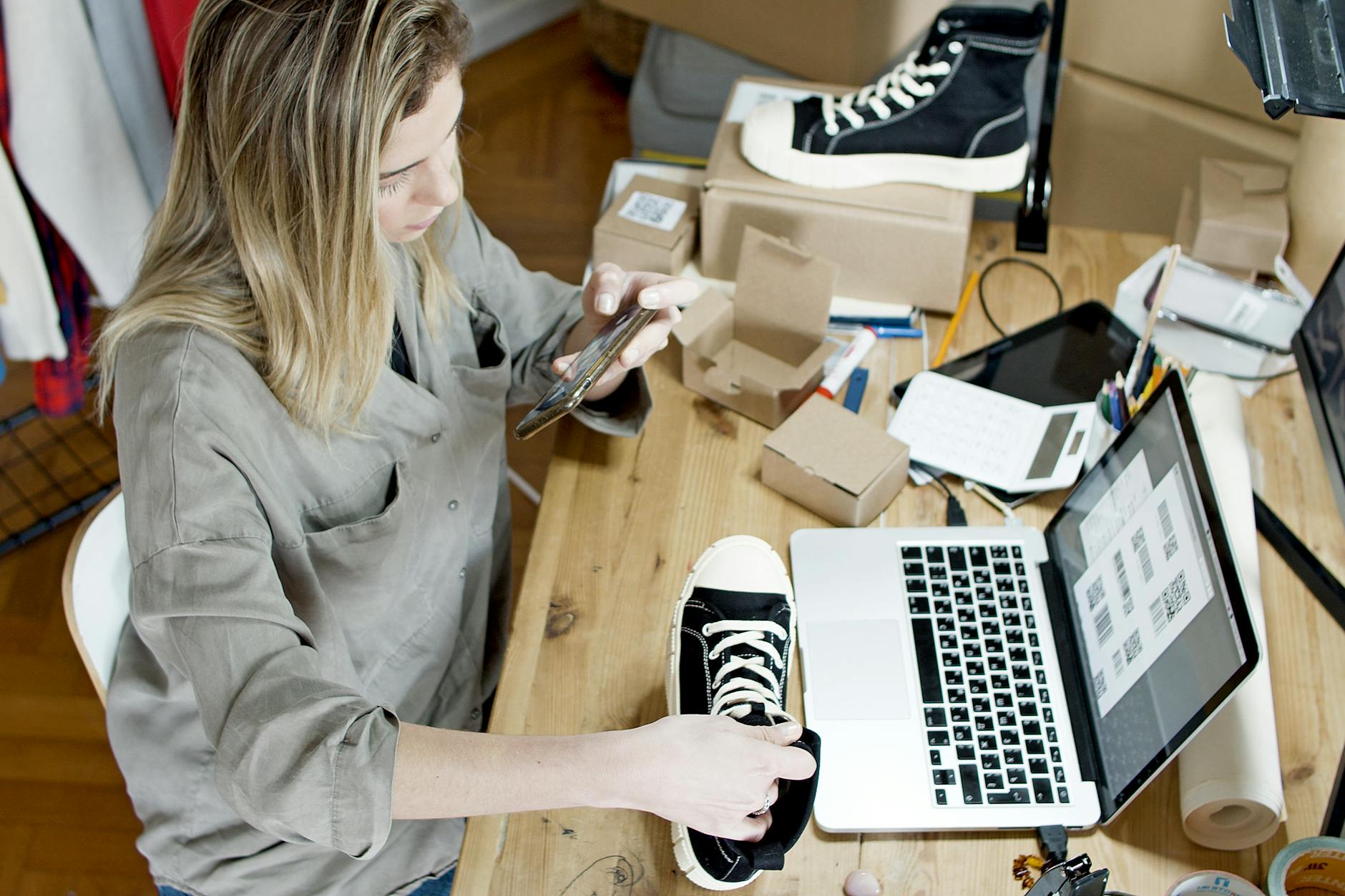 Small business owner creating multiple social media posts from one product photo on laptop