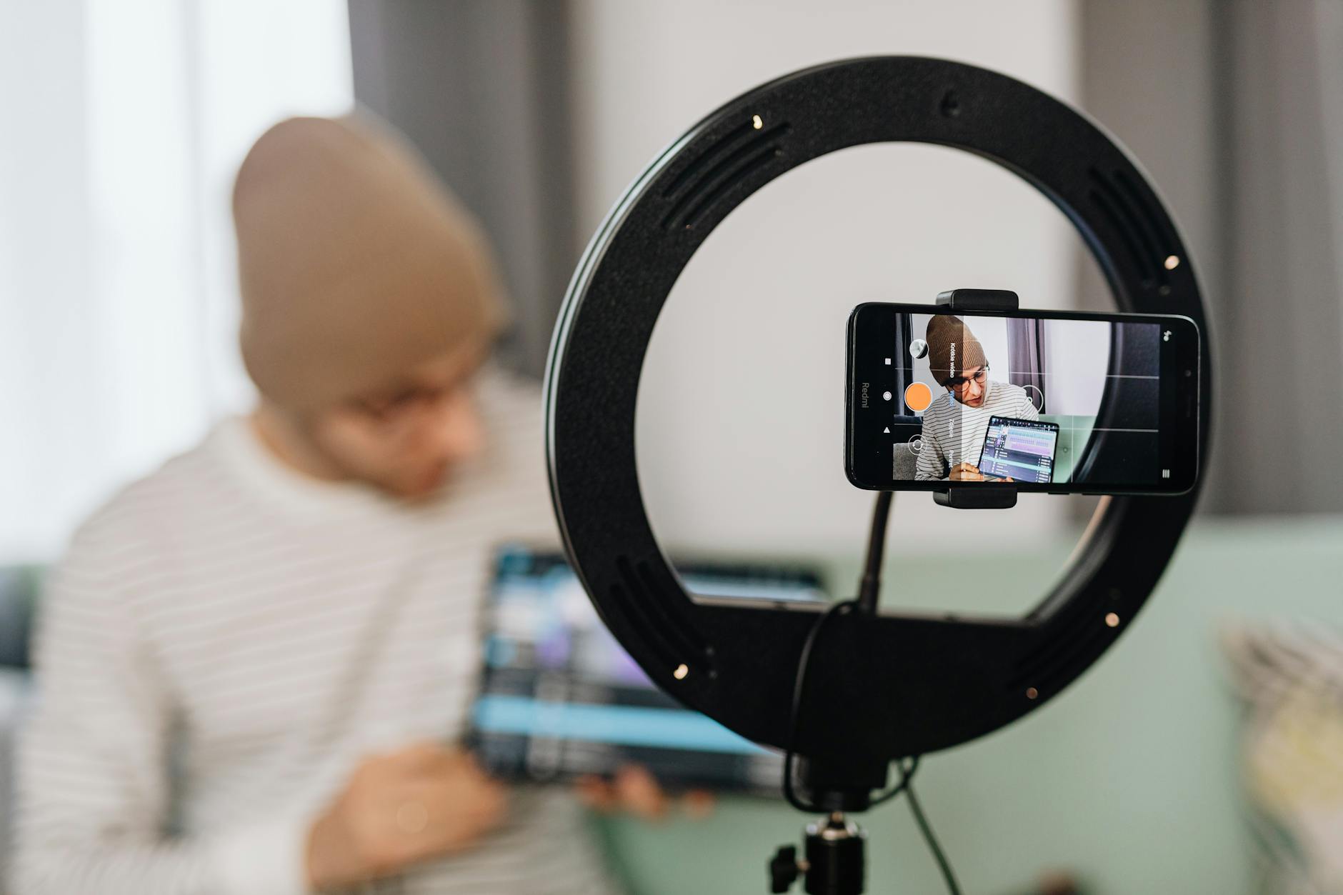 Content creator filming TikTok video with professional lighting setup