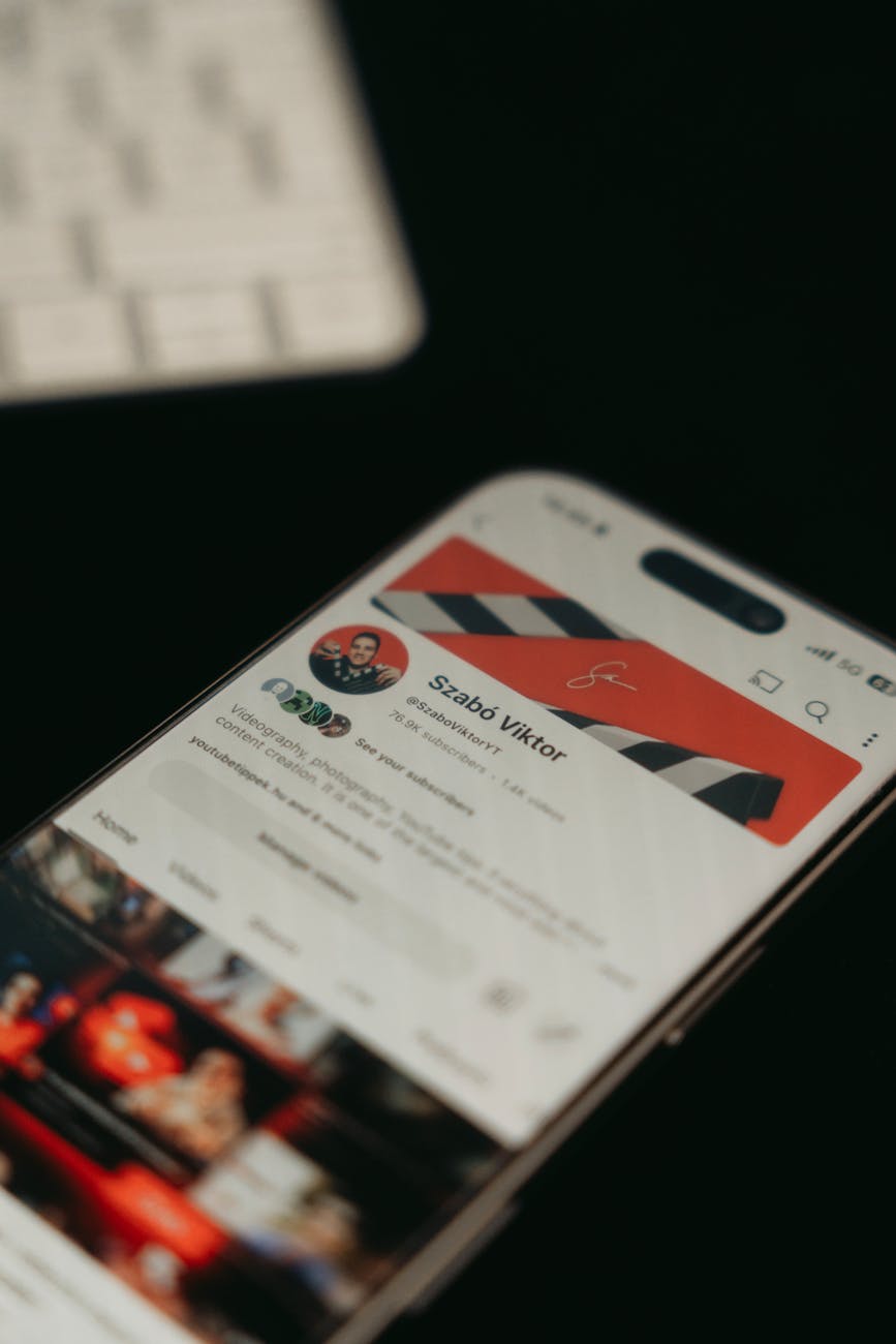 A smartphone showing a YouTube channel page screenshot in focus with blurred background.