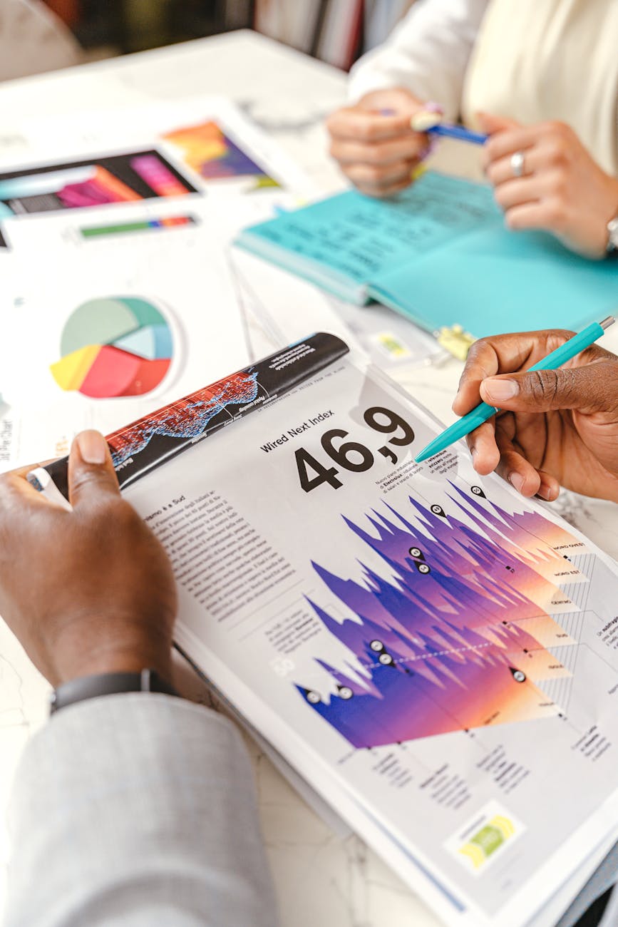 Team working on marketing strategy using data charts and papers in an office meeting.