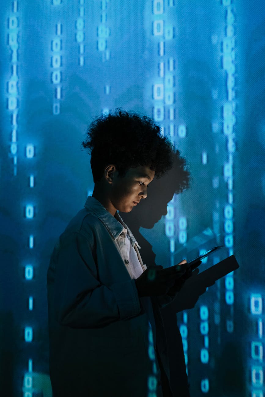 Young boy engrossed in a tablet, surrounded by a futuristic digital matrix.